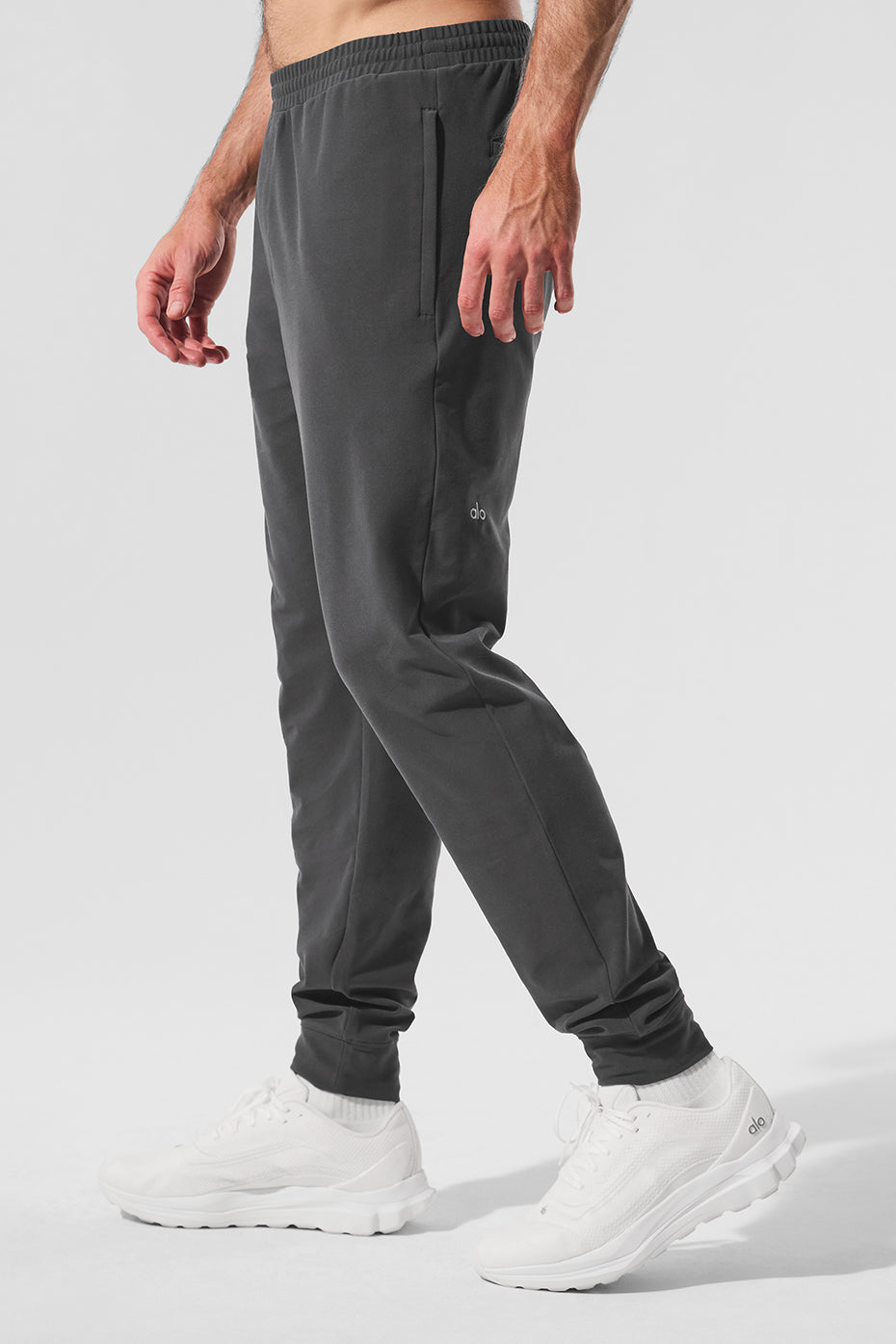 Casual shot of a man relaxing in mens activewear, emphasizing comfort and style.