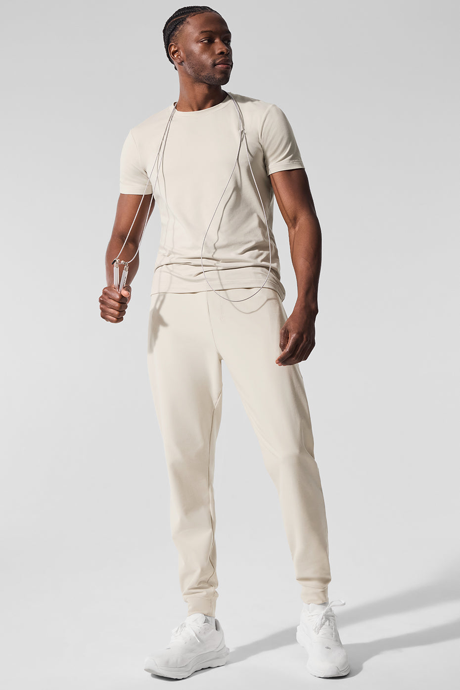 Man stretching in athletic wear performance joggers outdoors