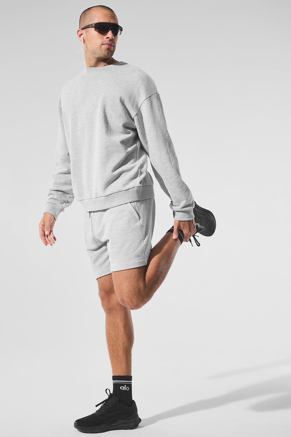 Model wearing athletic shorts outdoors, showcasing side pockets