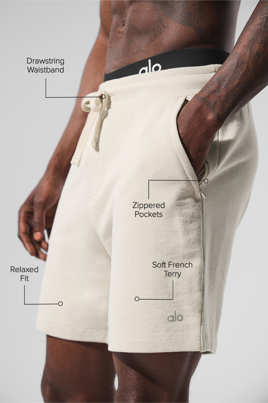 Side angle showing zip pockets on bone-colored lounge shorts