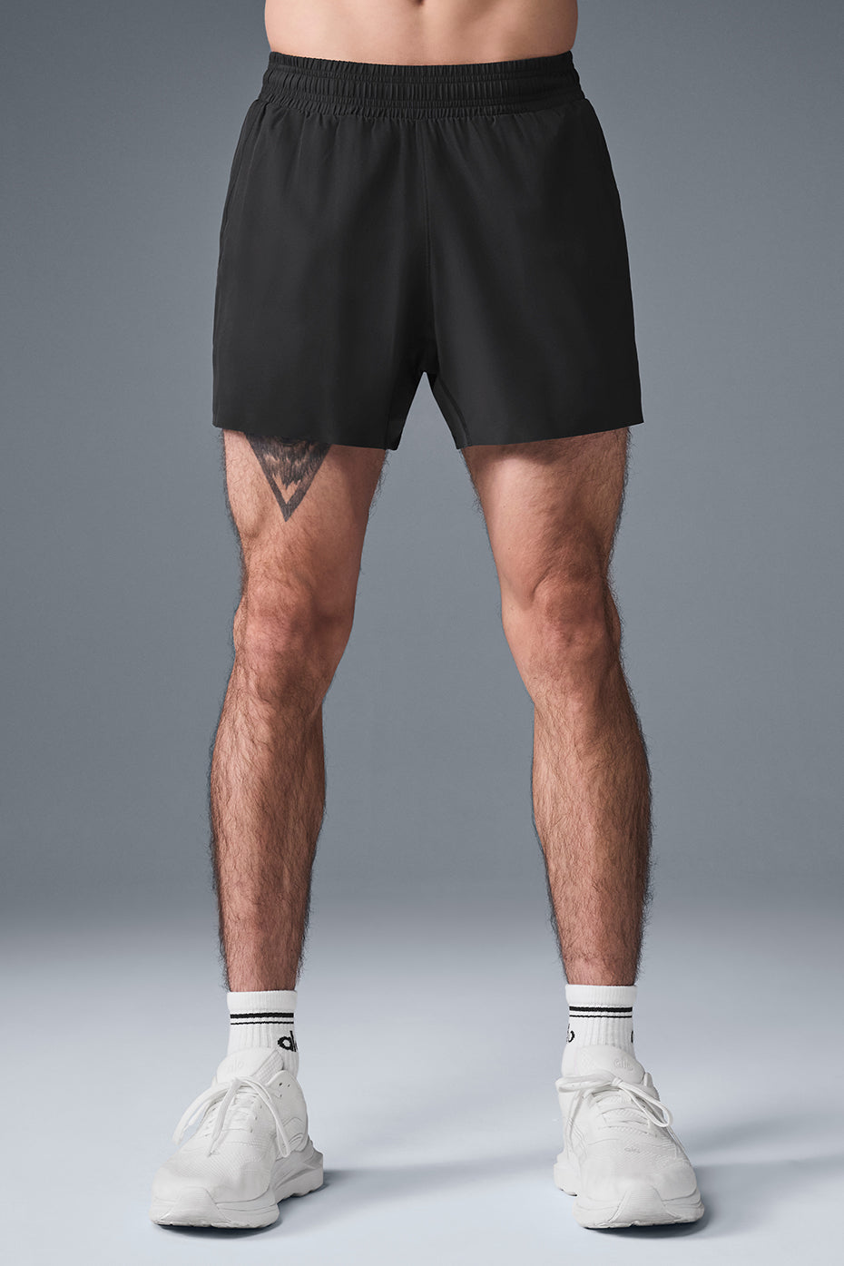 Front view of Adapt 5-inch men's running shorts in black, showcasing the breathable fabric.
