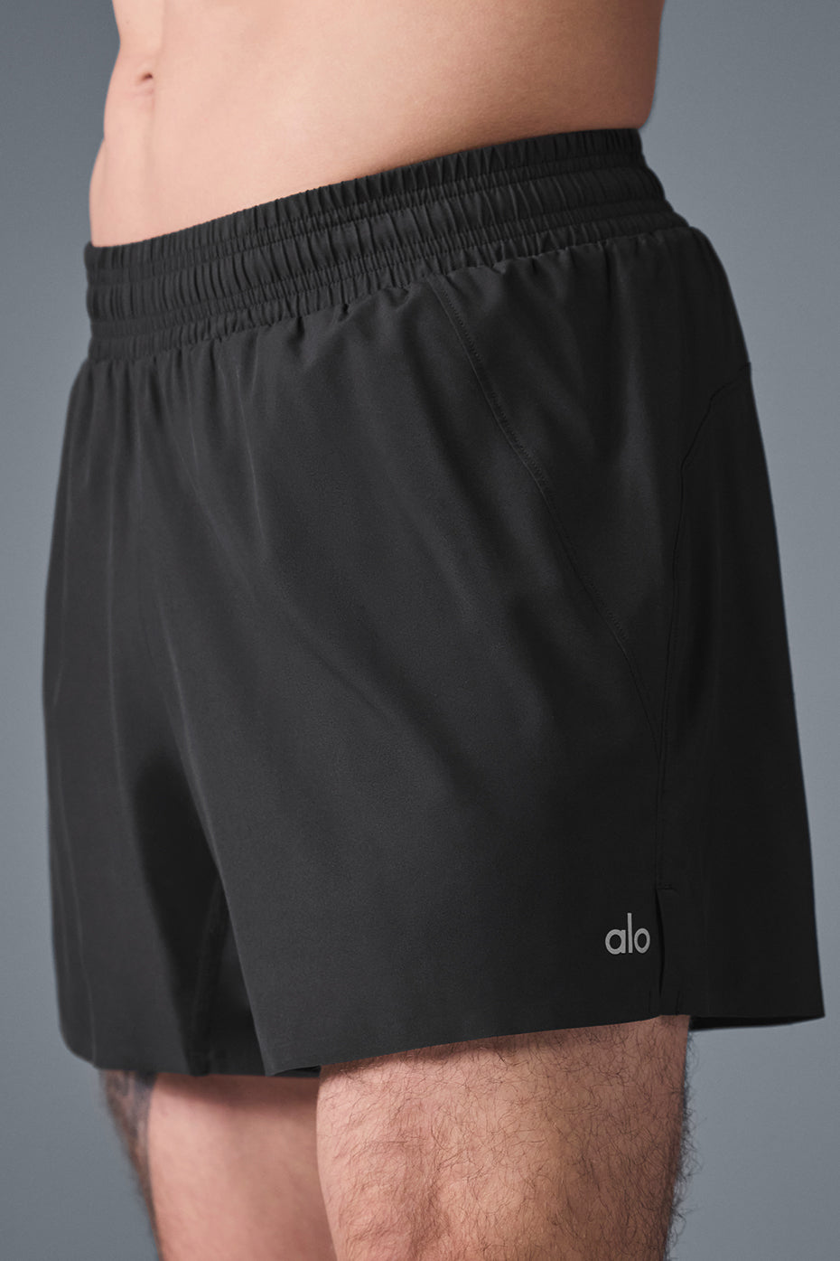 Front view of Adapt 5-inch mens running shorts in black, showcasing the breathable fabric.