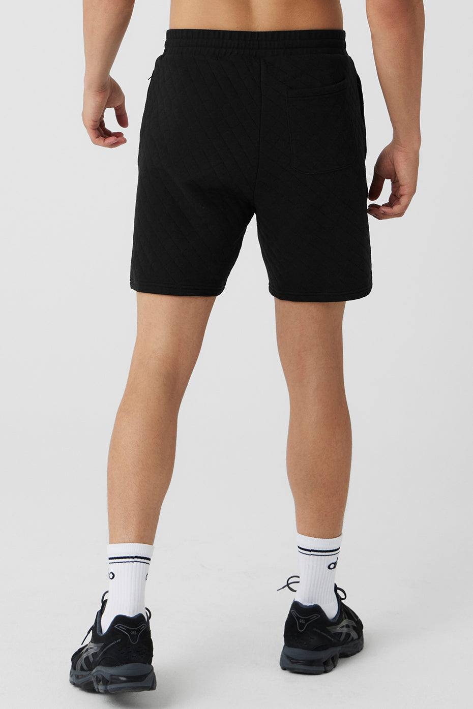 Model wearing black Lululemon athletic shorts during workout outdoors