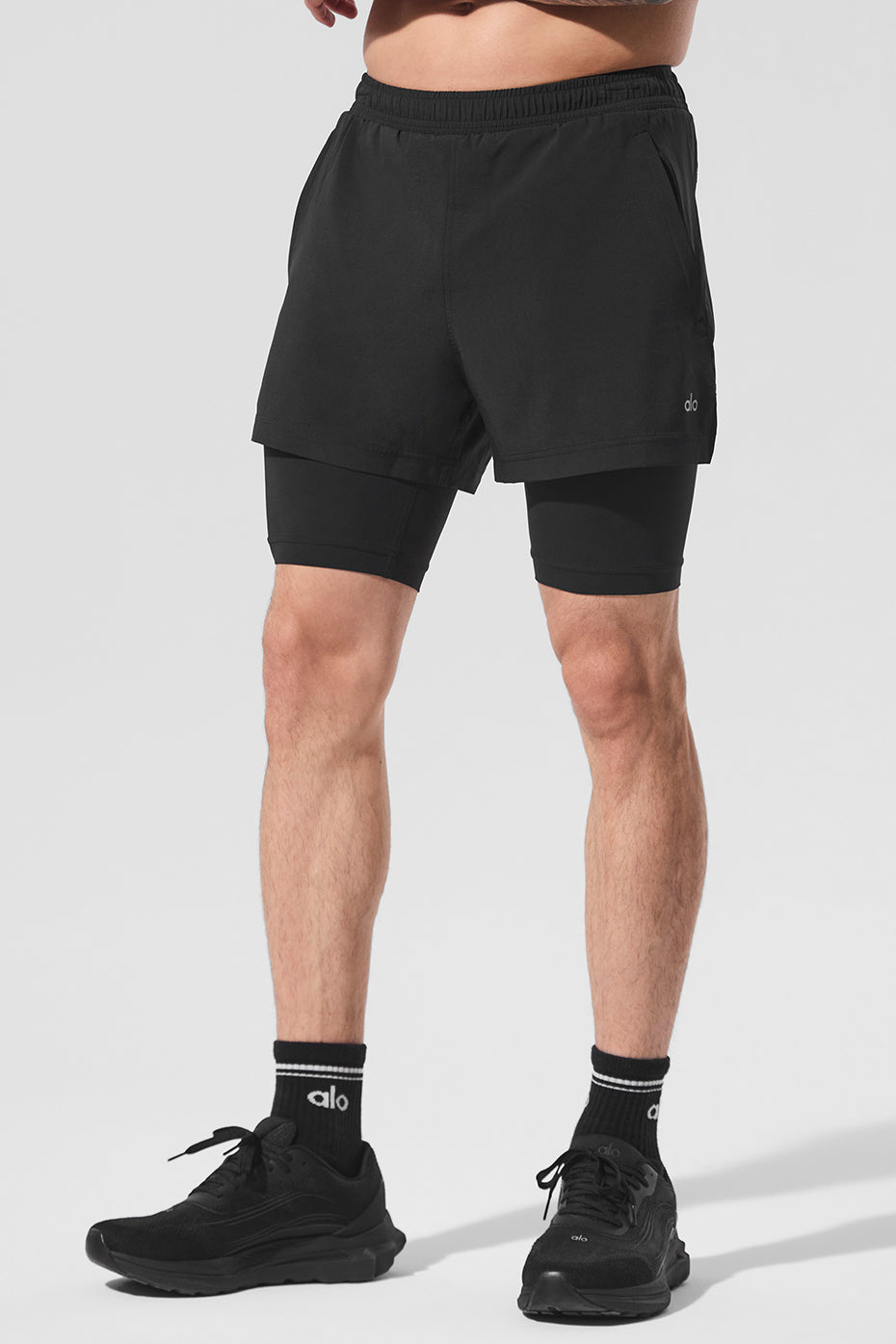 Front view of black 2-in-1 athletic shorts with zippered pockets