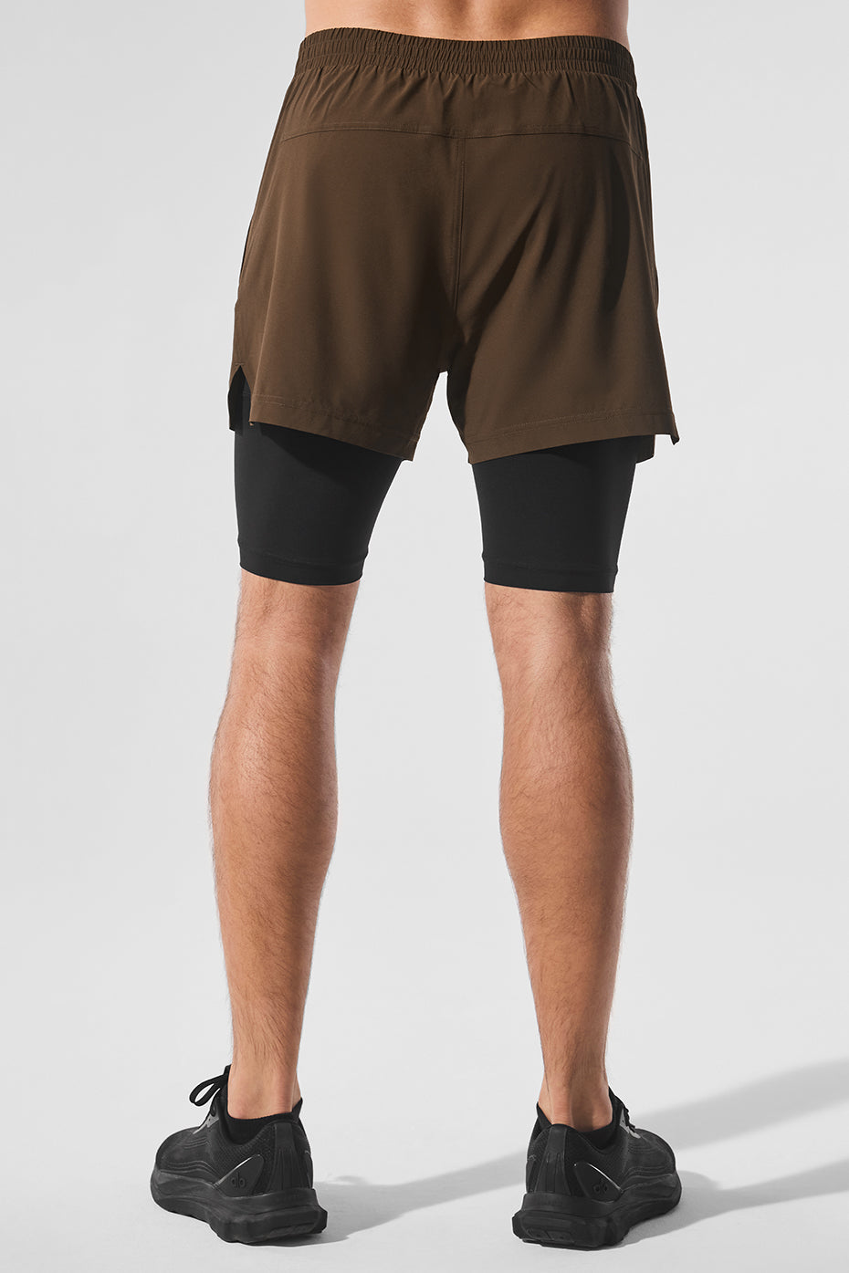 Side view of a runner in Revival 2-in-1 shorts, highlighting the breathable fabric during a jog.