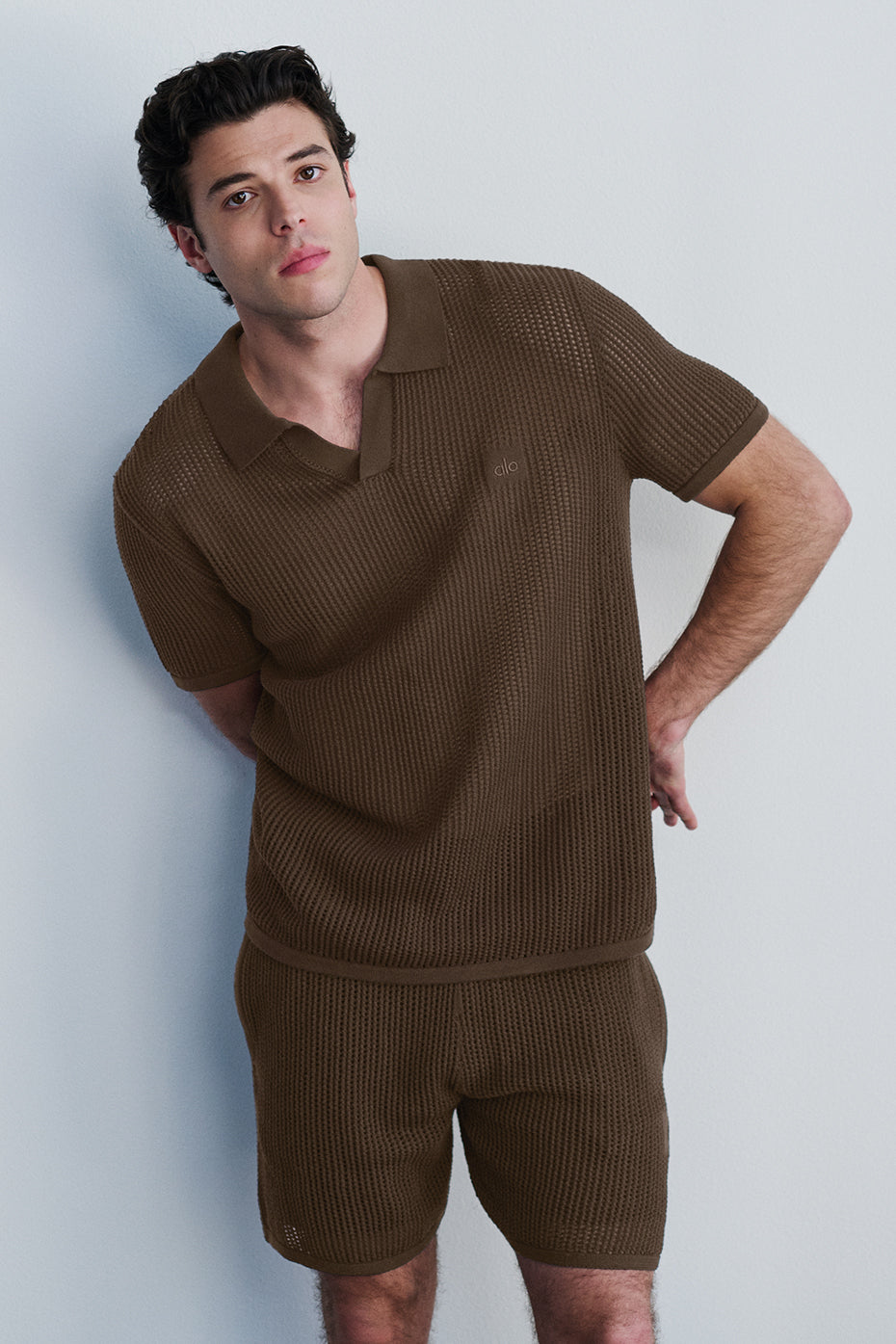 Flat-lay image of open-knit shorts, inner liner visible for performance detailing