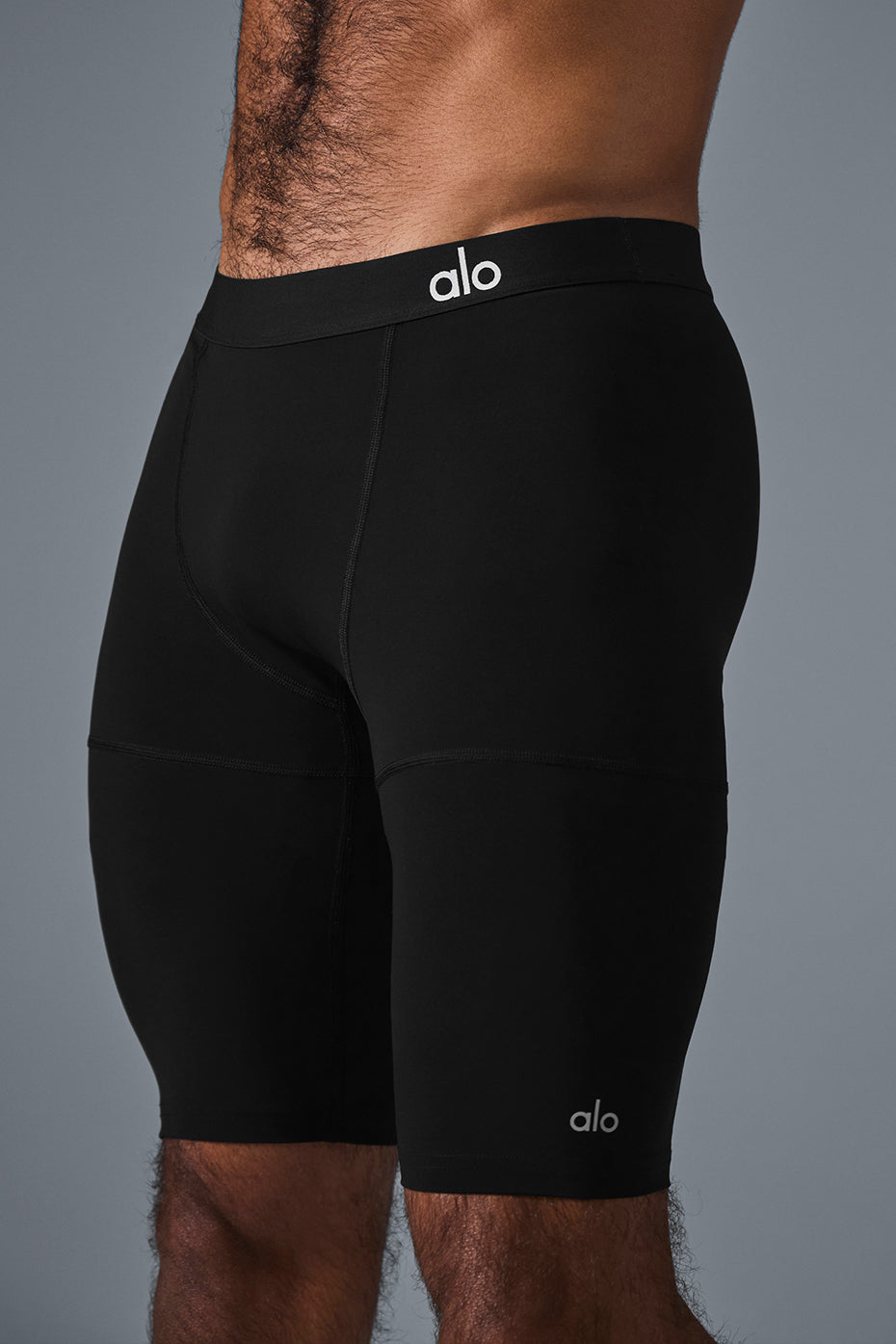 Men’s Flight Compression Shorts stretched for flexibility, black fabric with reflective detail