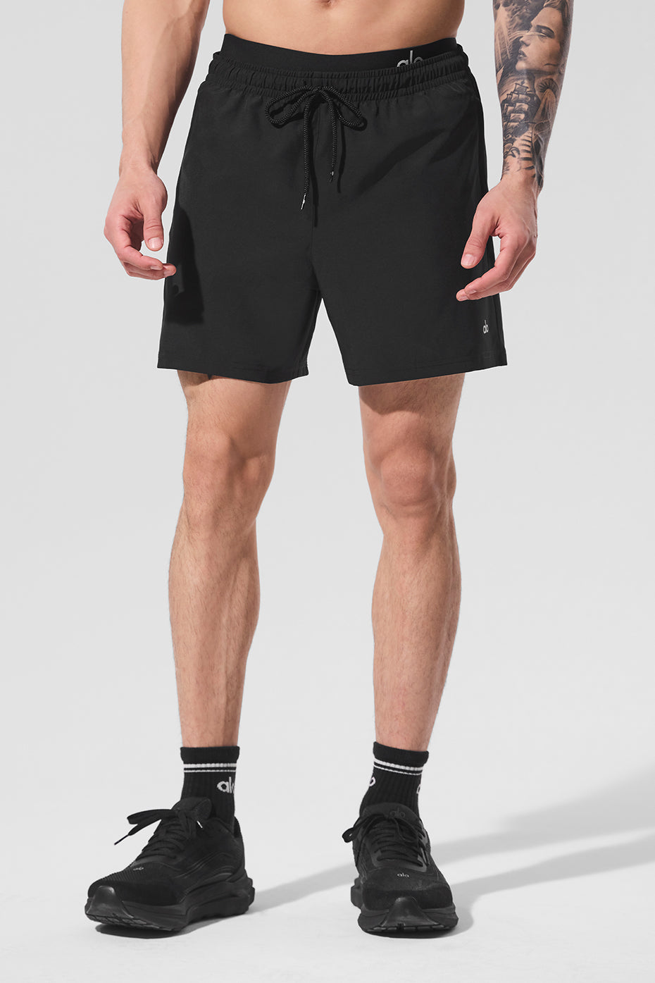 Front view of black 7-inch gym shorts for men, showcasing the relaxed fit.