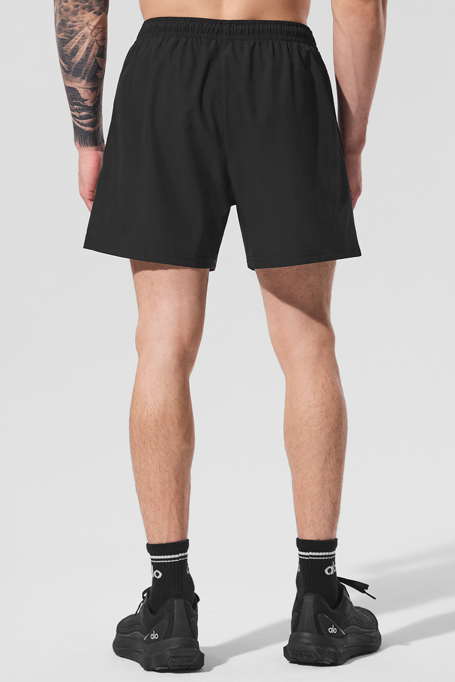 Back view of black workout shorts, highlighting the stretchy drawstring waist.