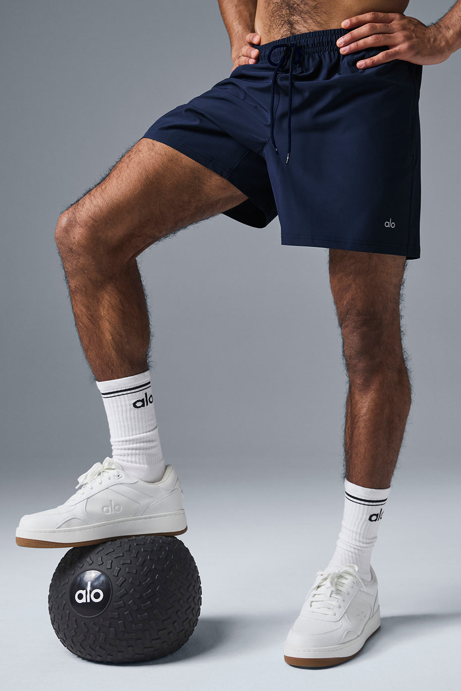 Model wearing navy shorts during an outdoor workout.