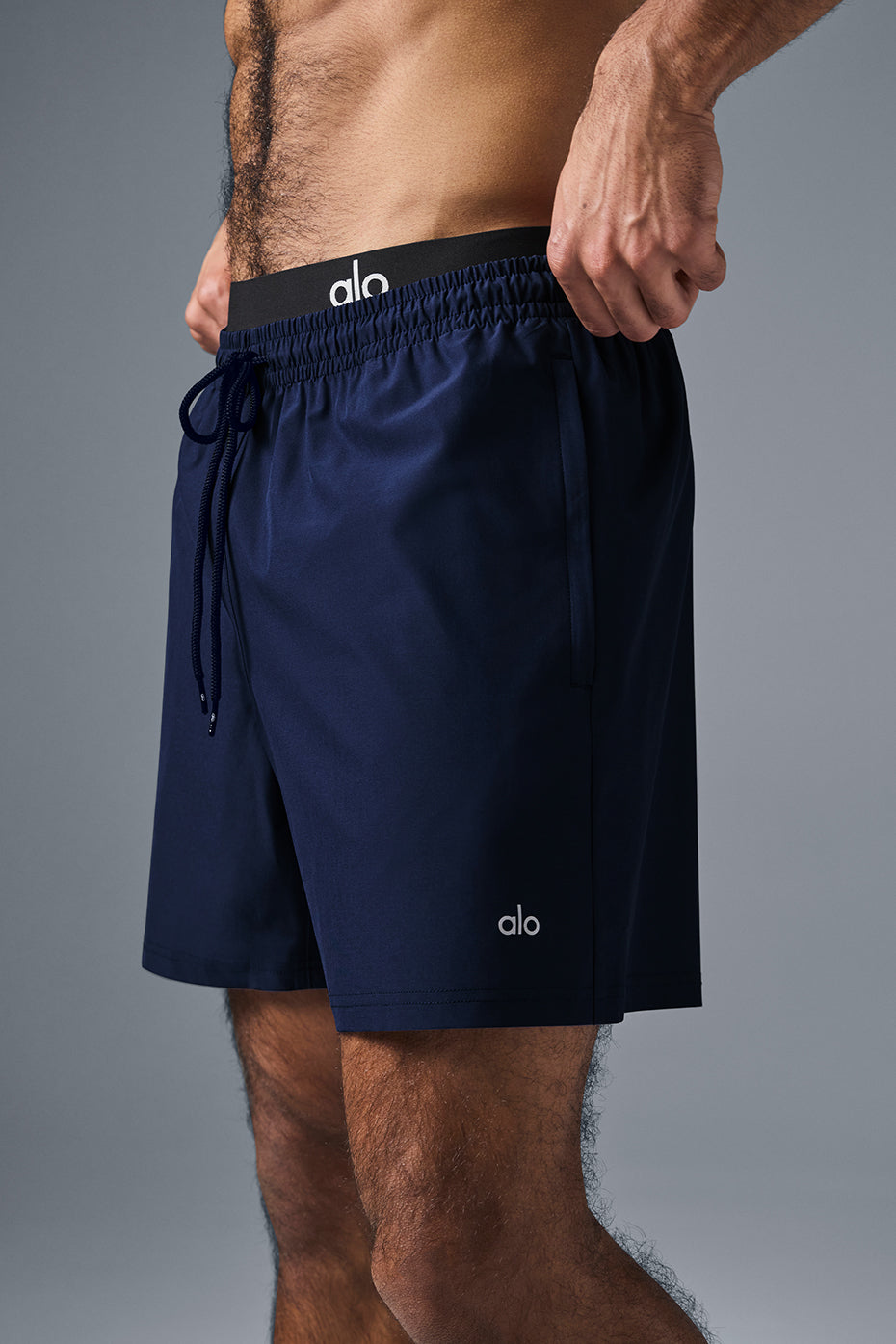 Side view showcasing the deep zippered pockets of the gym shorts.