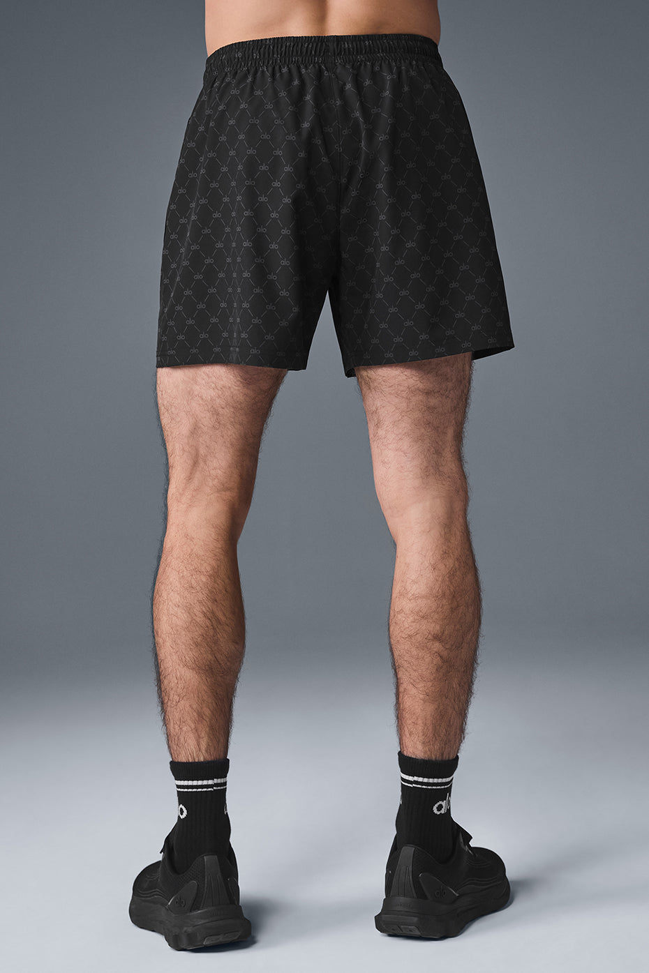 Back view of the performance shorts with zippered pockets and ALO logo design.