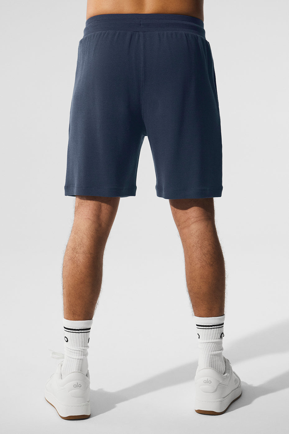 Close-up of the waffle knit texture on mens cotton drawstring shorts.