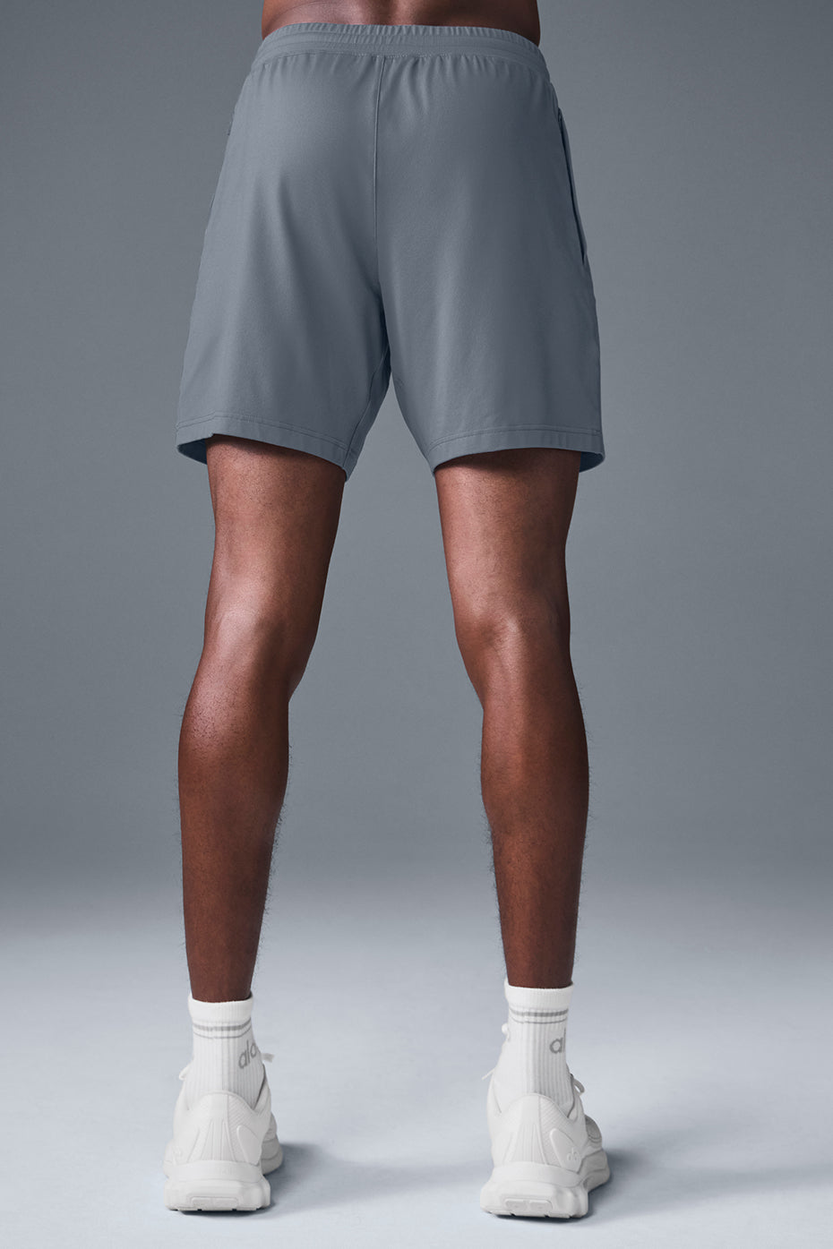 Side view of lightweight mens workout shorts with liner in a gym setting
