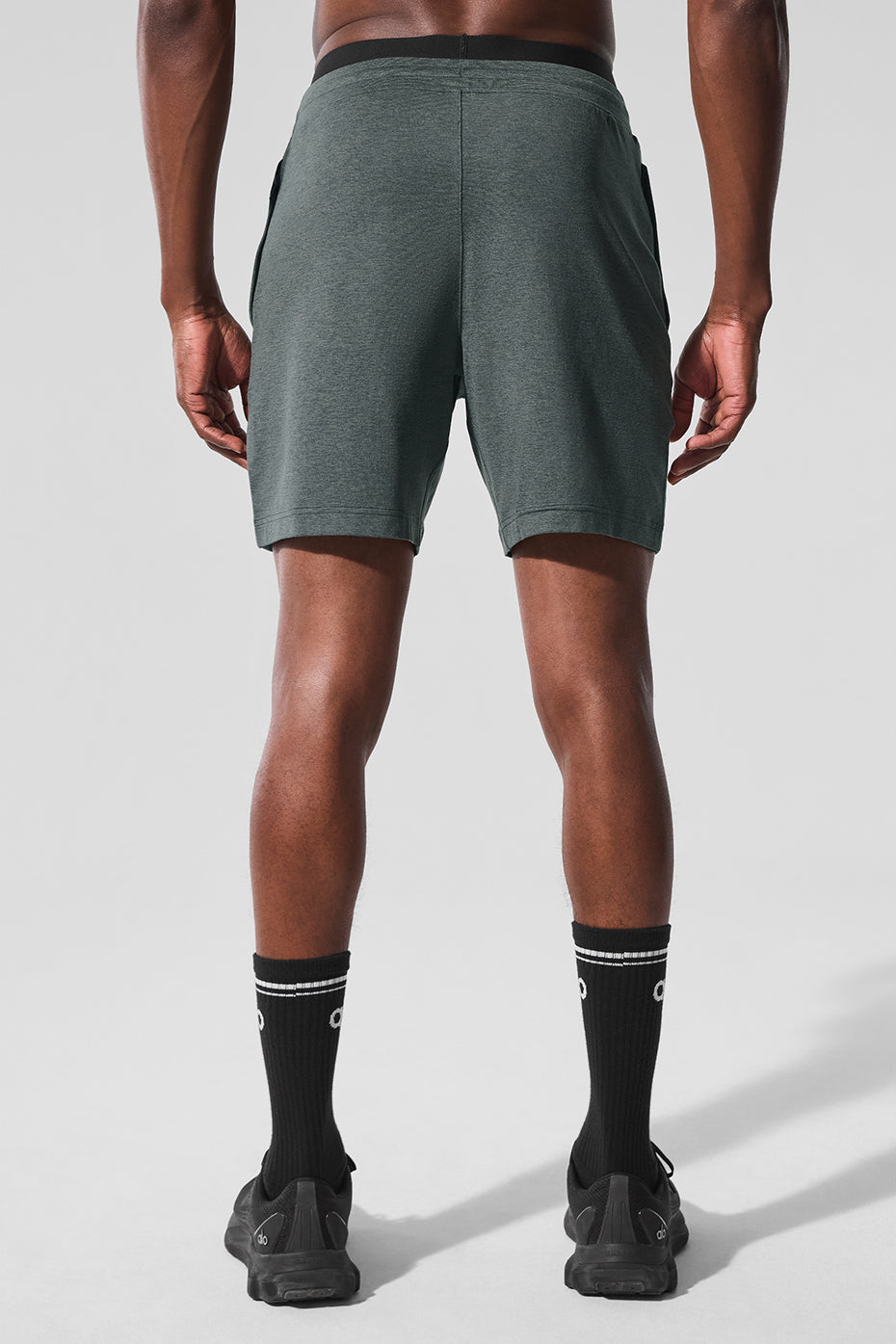 Athlete wearing charcoal green training shorts during a sprint workout