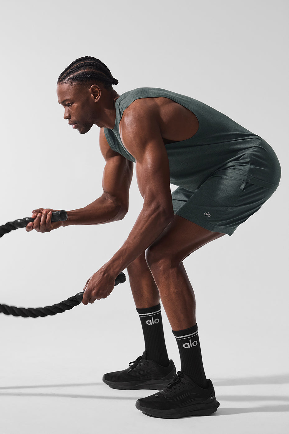 Athlete wearing charcoal green training shorts during a sprint workout