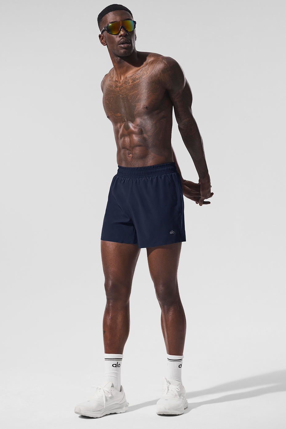 Men’s navy 5-inch running shorts on a runner mid-stride.