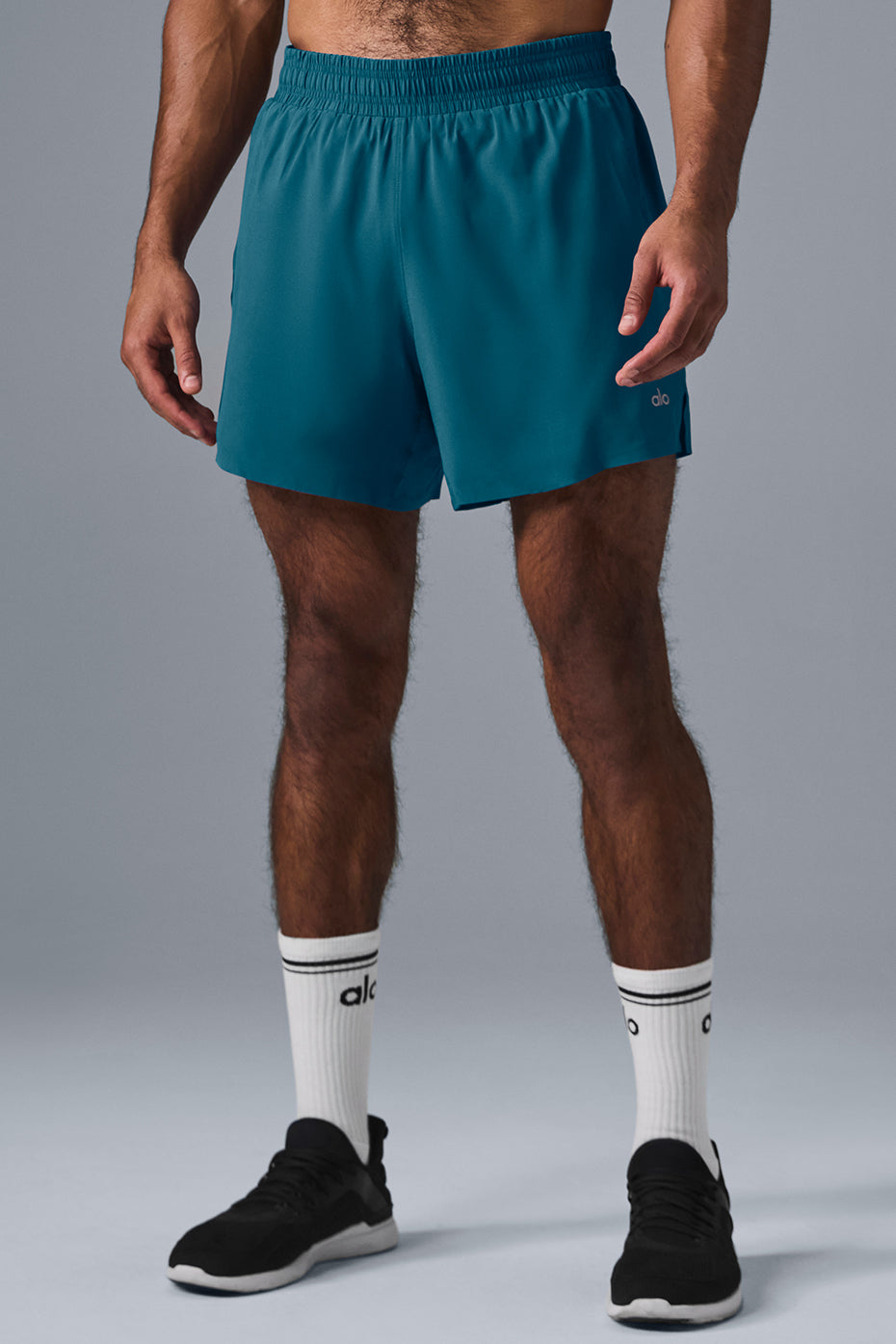Front view of Oceanic Teal 5-Inch Adapt Performance Shorts on a running trail.