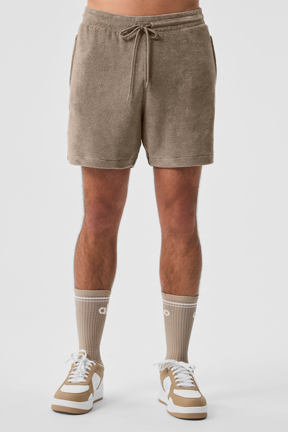 Front view of gravel coastal terry shorts on a sunny day.