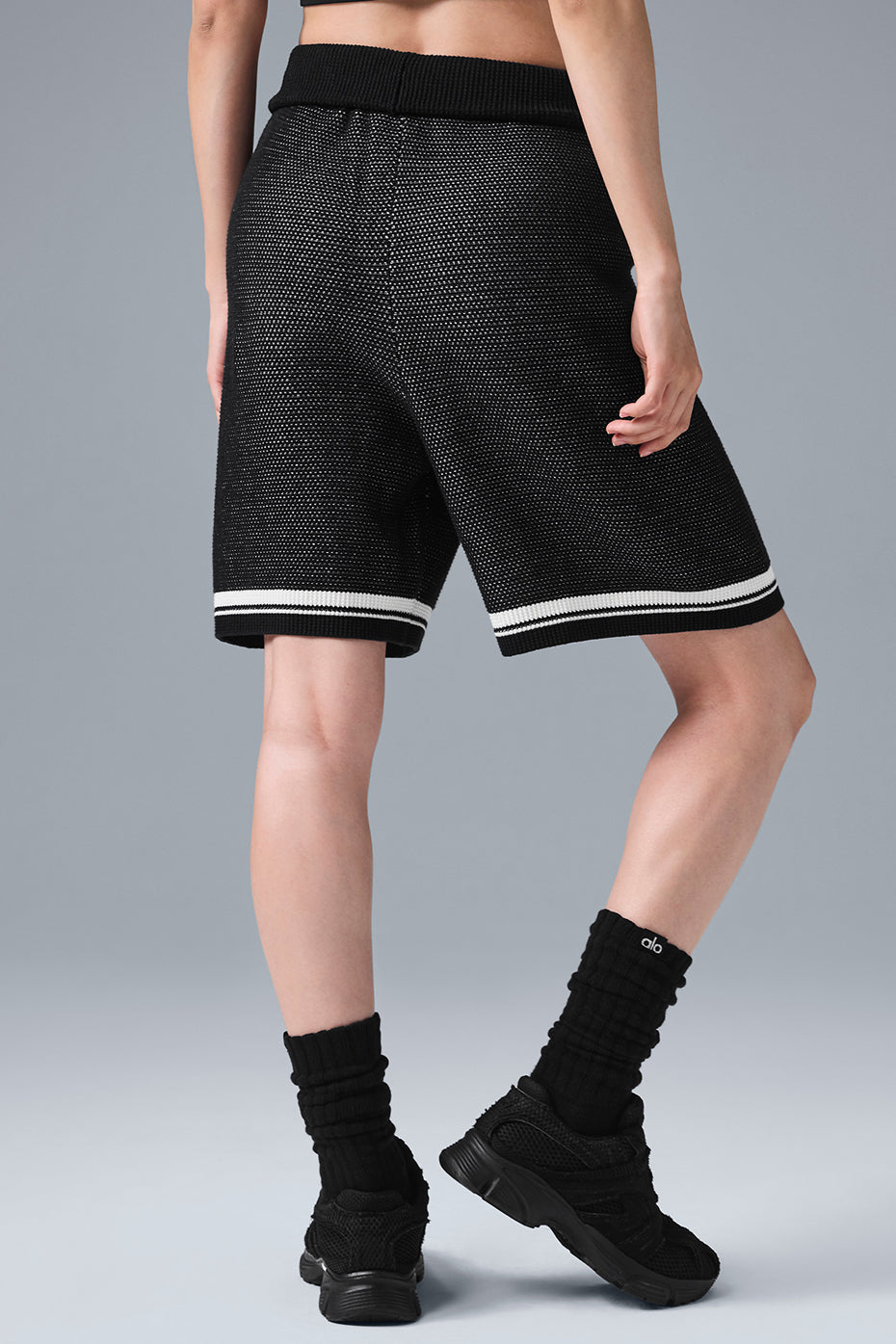 Front view of black sports club shorts for women, showcasing the knit texture.