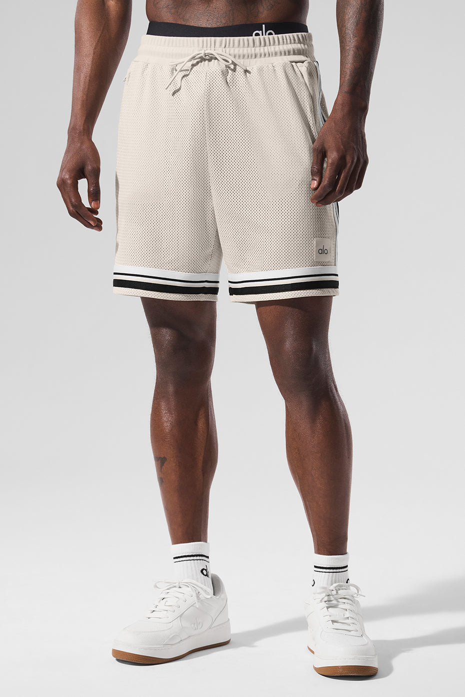 Side view of breathable sports shorts showing zippered pockets.