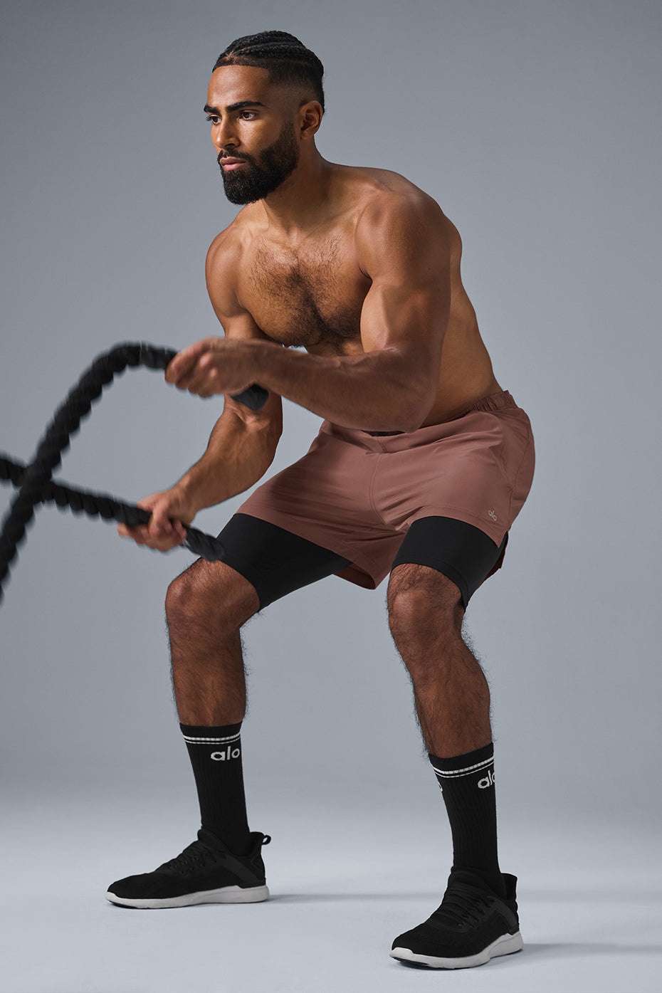 Front view of Revival 2-in-1 performance shorts in chestnut and black, showcasing the outer shell and inner compression shorts.