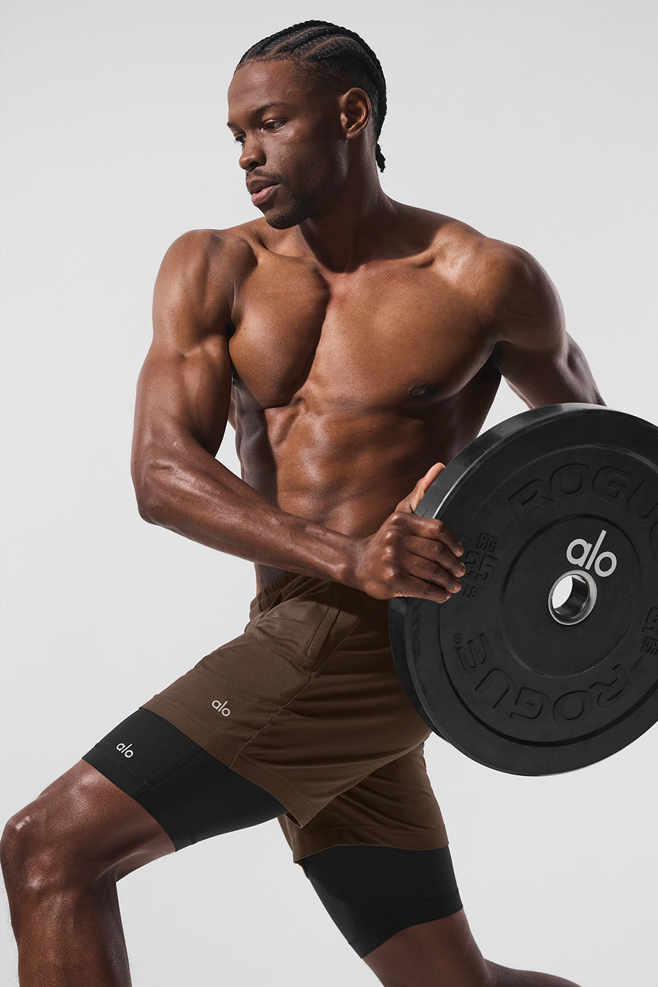 Mens performance shorts with built-in compression layer in action during workout
