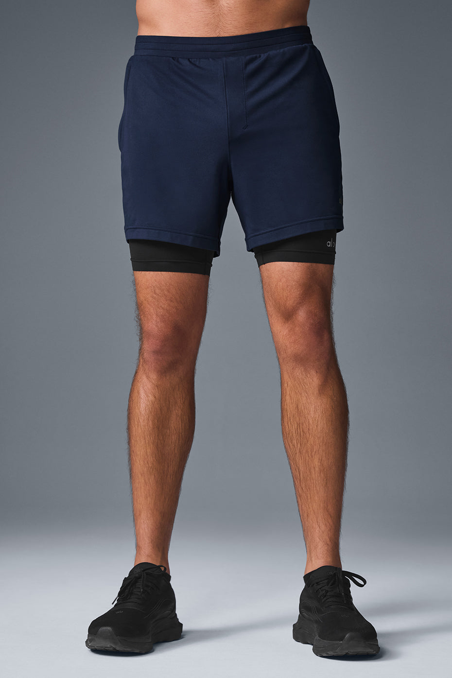 Side view of Conquer 2-In-1 Performance Shorts showcasing built-in compression shorts.