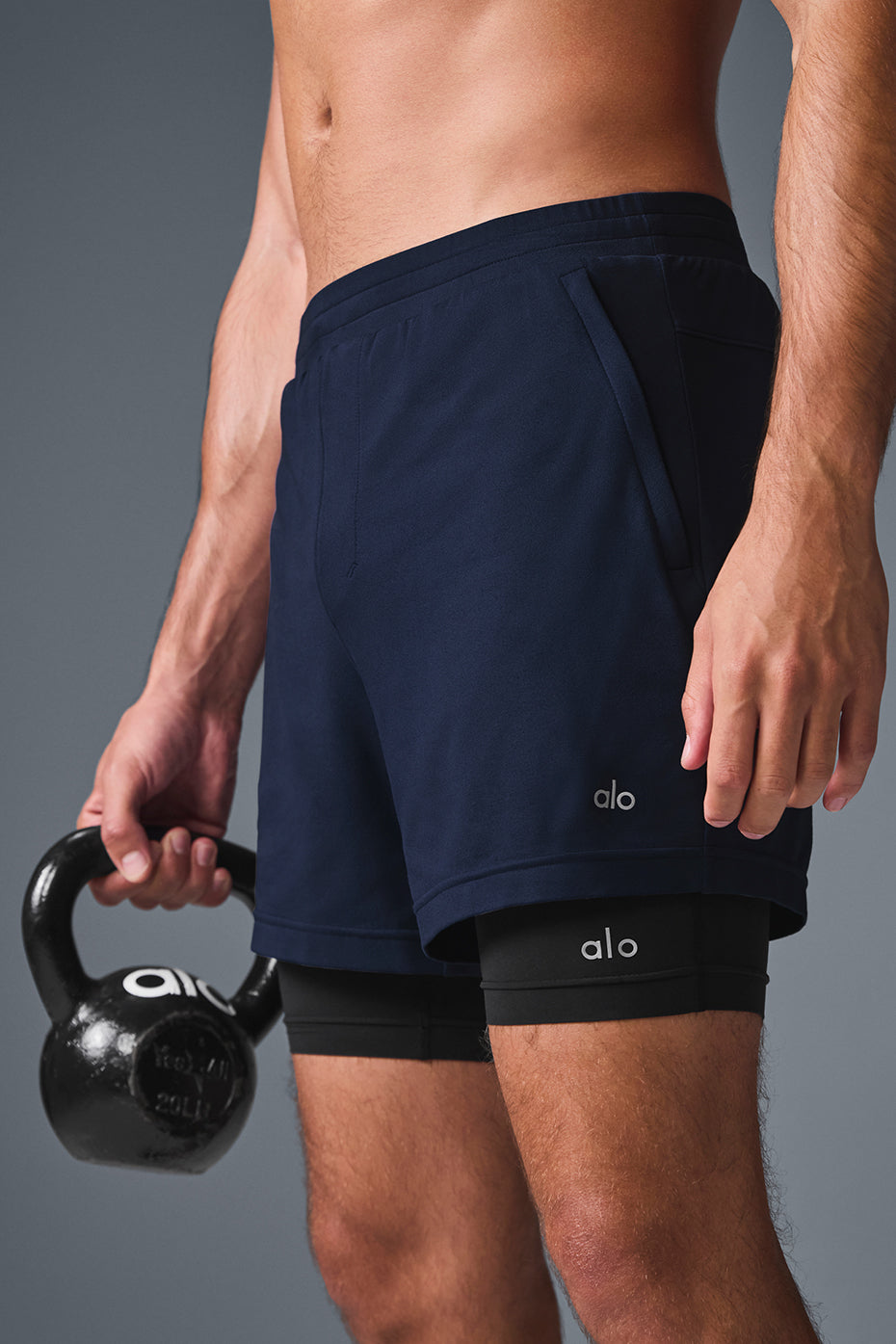 Side view of Conquer 2-In-1 Performance Shorts showcasing built-in compression shorts.