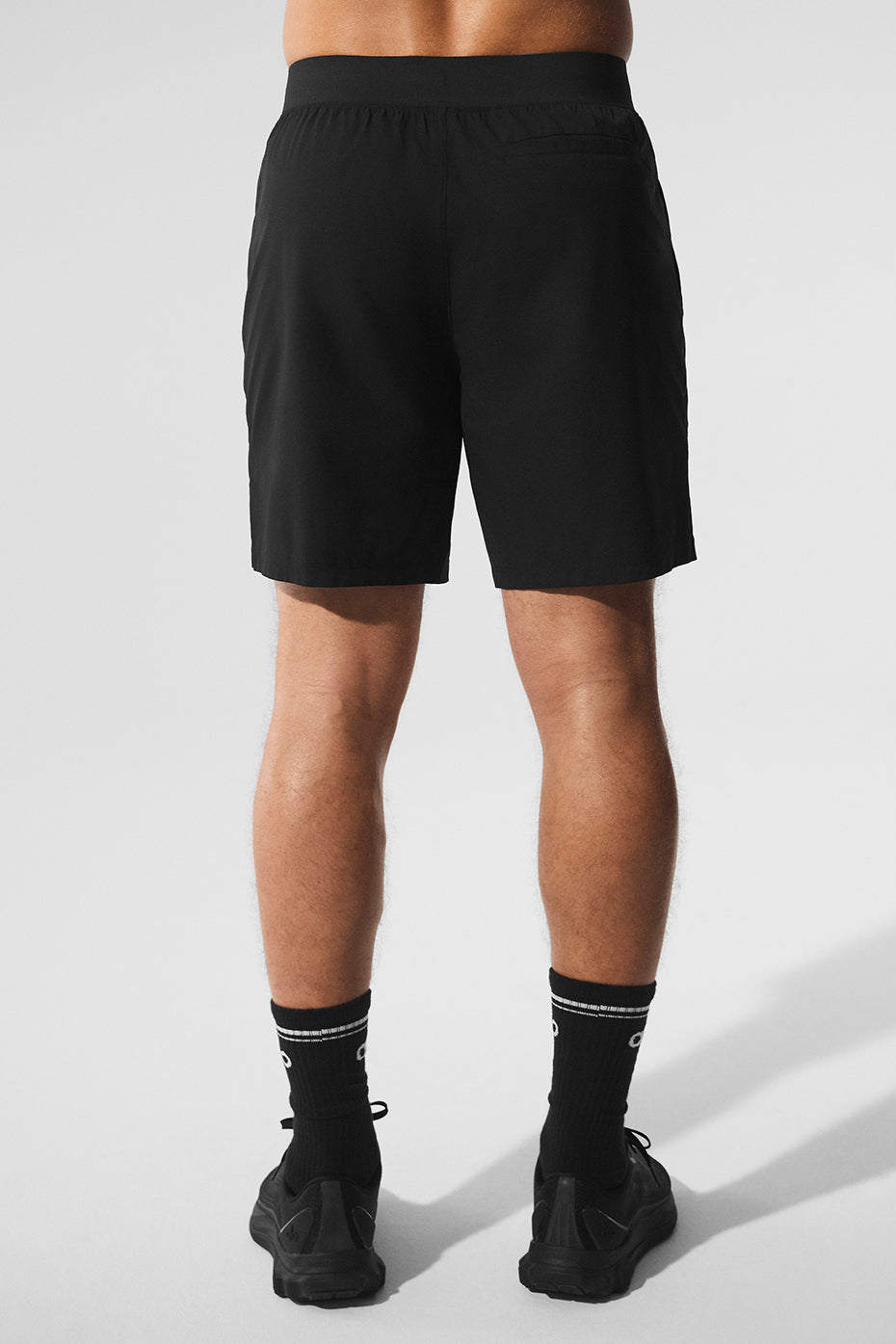 Side view showcasing the side-slit styling of the running shorts.