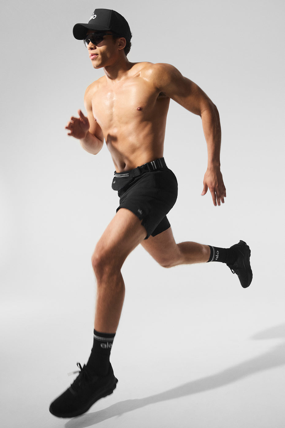 Front view of black running shorts with zip pockets and drawcord.