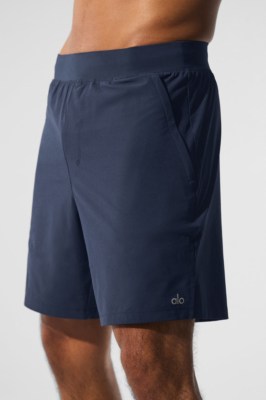 Close-up of navy performance shorts highlighting the side-slit design.