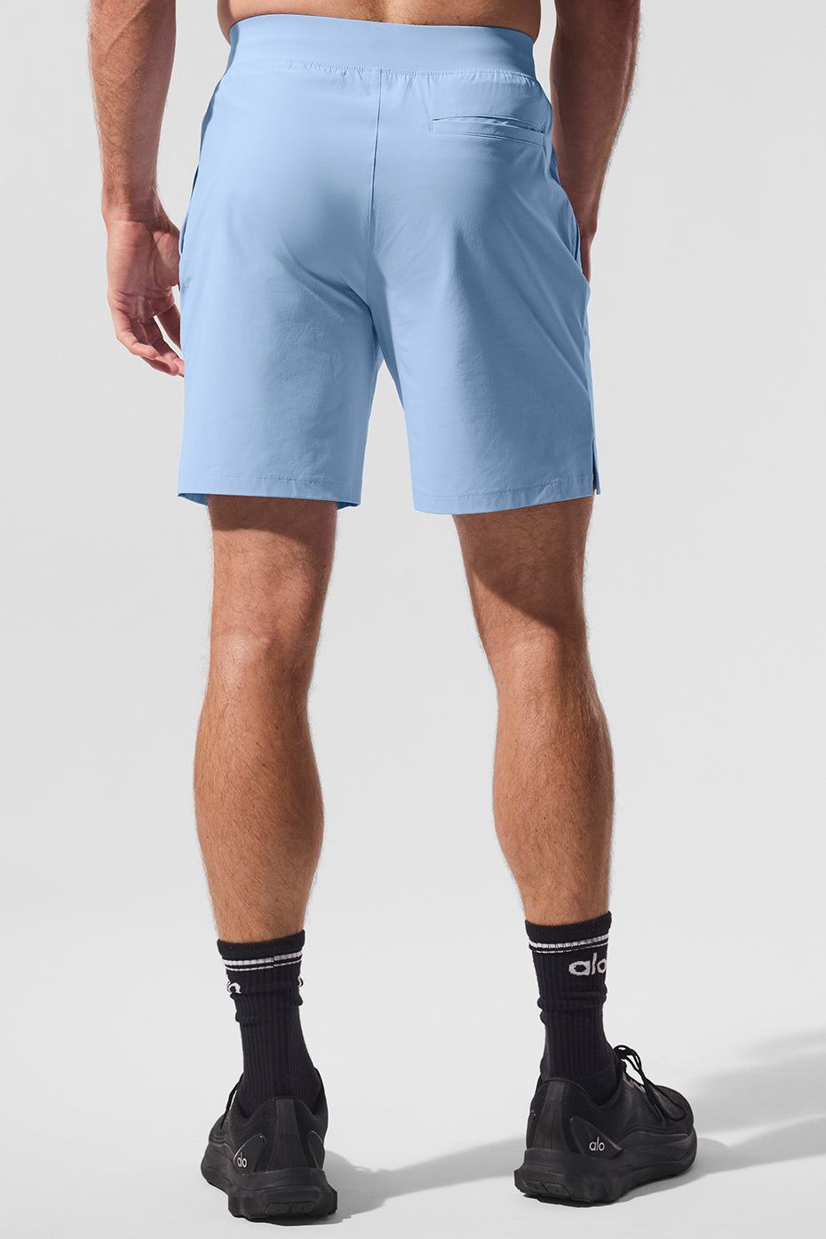 Mens athletic shorts with pockets, showcasing side-slit design and drawcord.