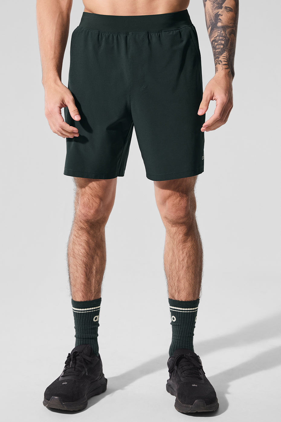 Charcoal green moisture-wicking shorts with zip pockets.
