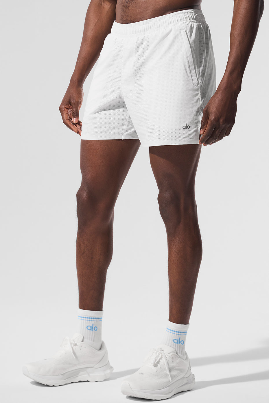 Side view showcasing the zippered pockets of mens running shorts.