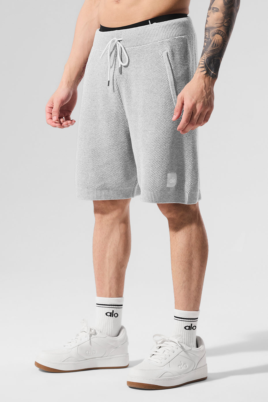 Close-up of the textured knit fabric on mens athletic shorts.