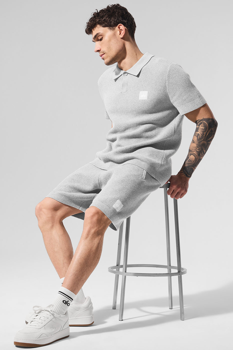 Model wearing knit mens shorts on a golf course.
