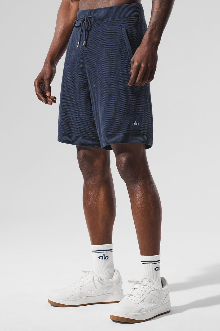 Front view of mens navy cotton knit shorts, styled casually.