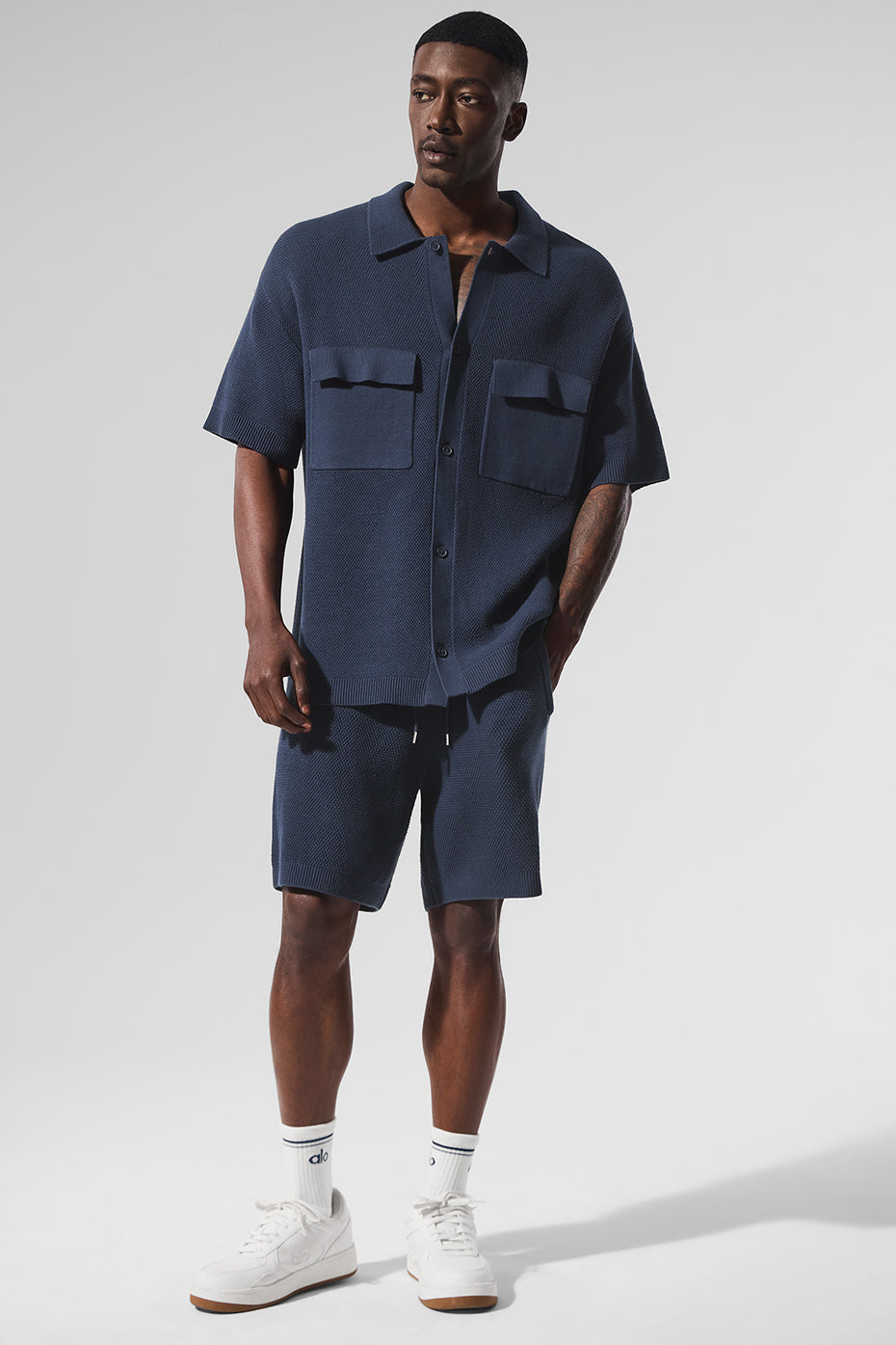 Side view showcasing the lightweight material of navy sports shorts.