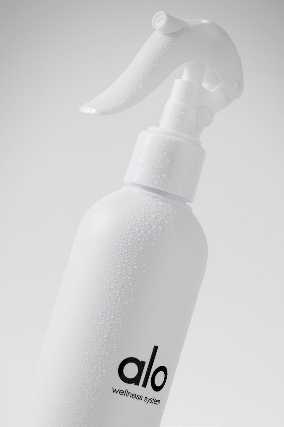 User spraying Eco Fresh Yoga Mat Spray on a yoga mat.