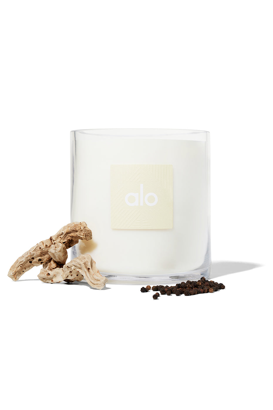 ALO Luxe Santal Candle displayed on a stylish coffee table.