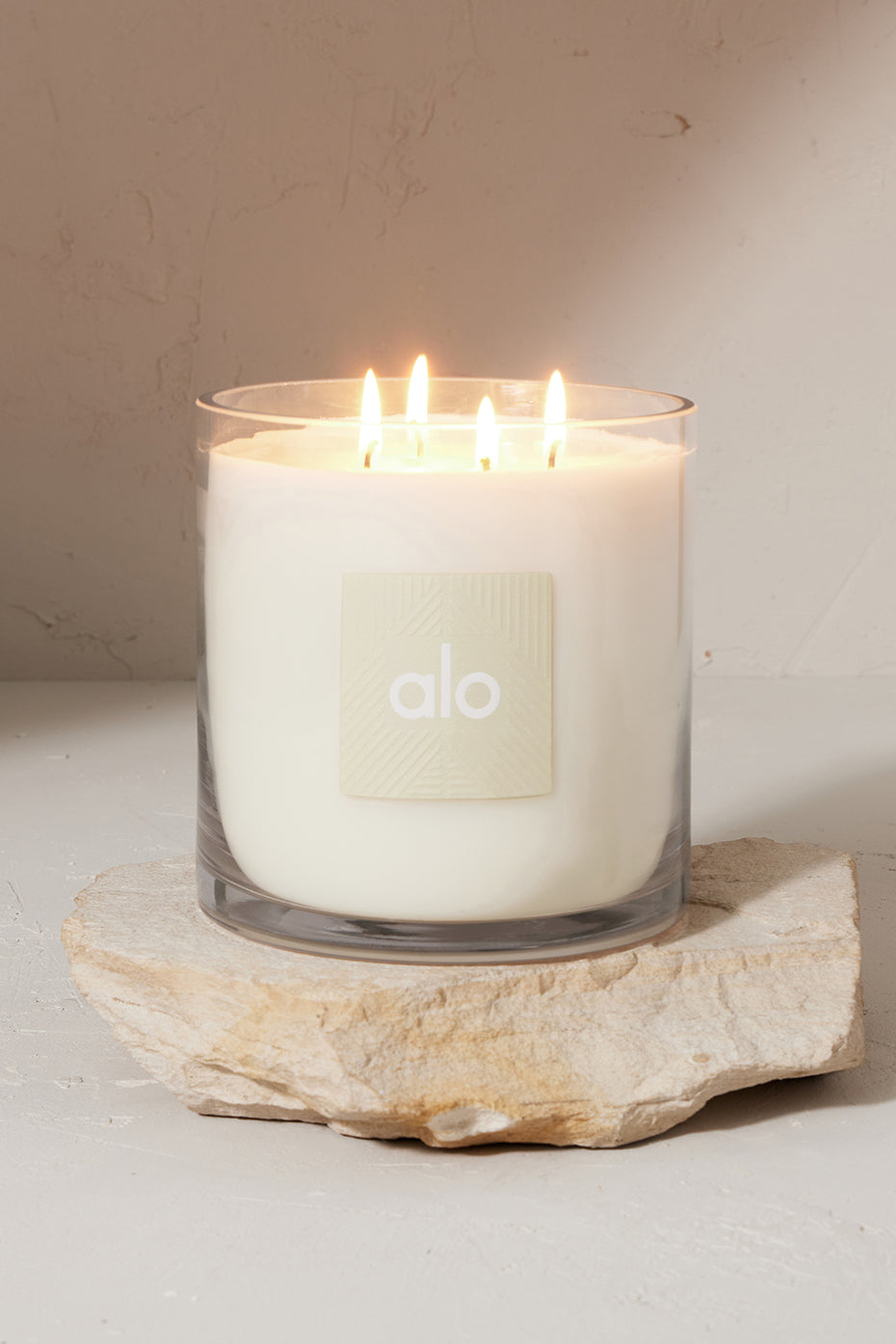 Cozy setting with Cedar Mist Holiday Candle lit, surrounded by holiday decor.