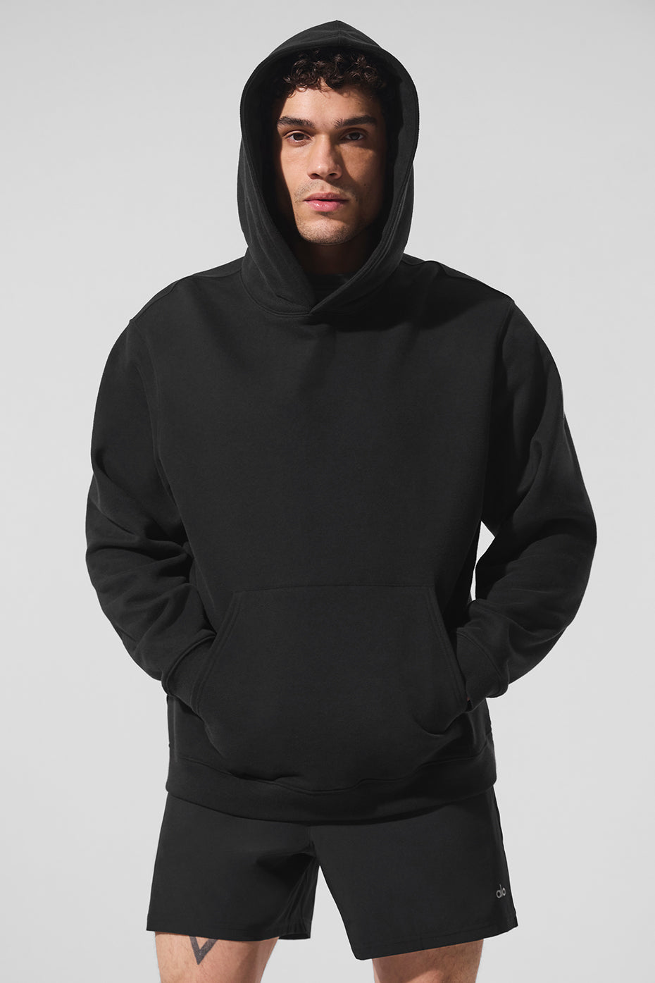 Front view of the heavyweight black zip-up hoodie, showcasing the kangaroo pocket.