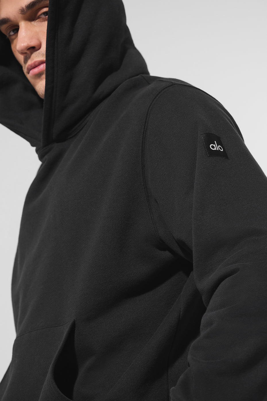 Back view of the black hoodie, emphasizing the comfortable fit and design.