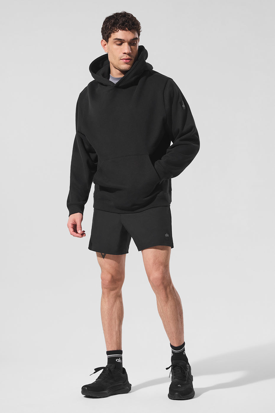 Front view of the heavyweight black zip-up hoodie, showcasing the kangaroo pocket.