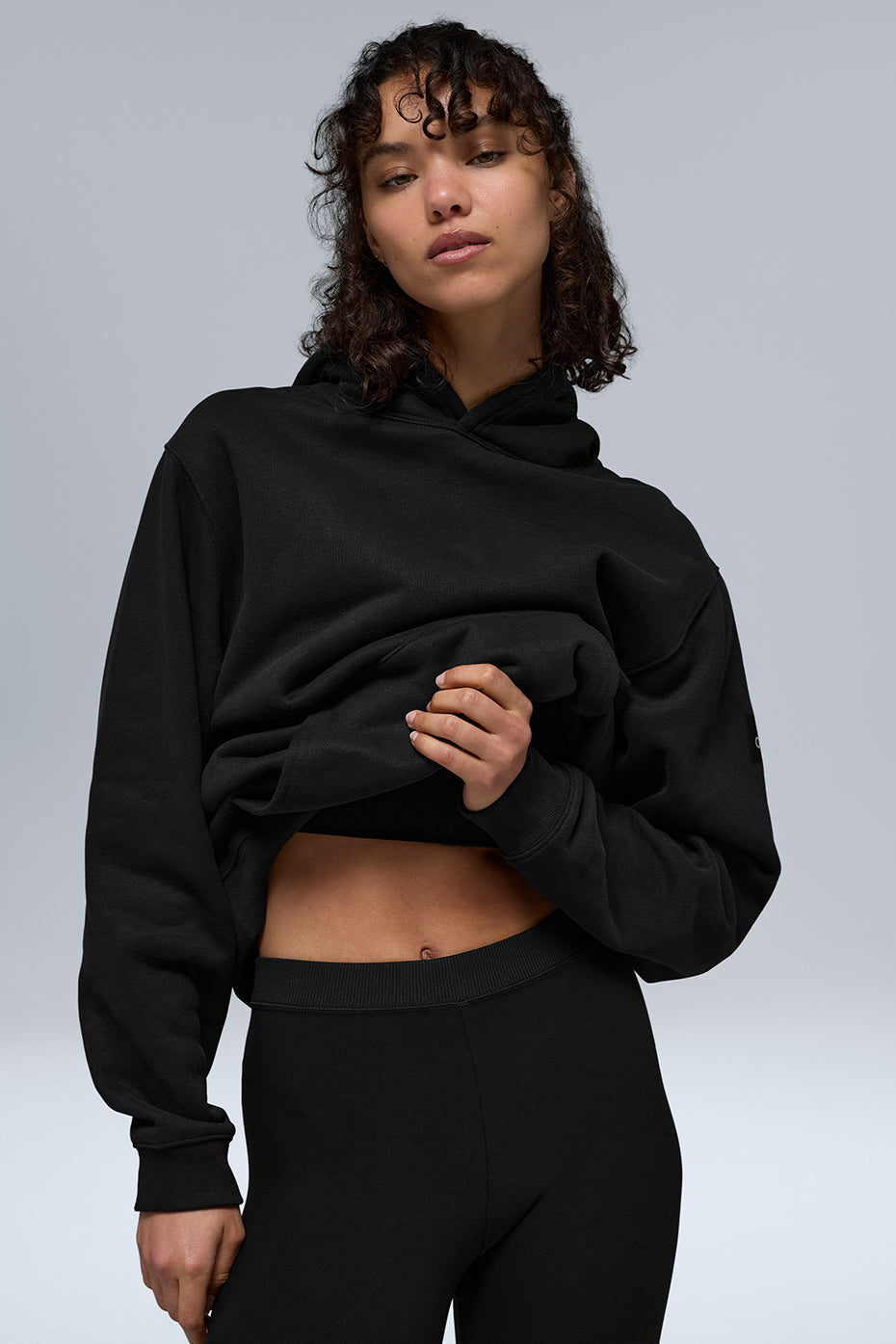 Side angle of heavyweight zip up hoodie, highlighting oversized fit and sleeve cuffs.