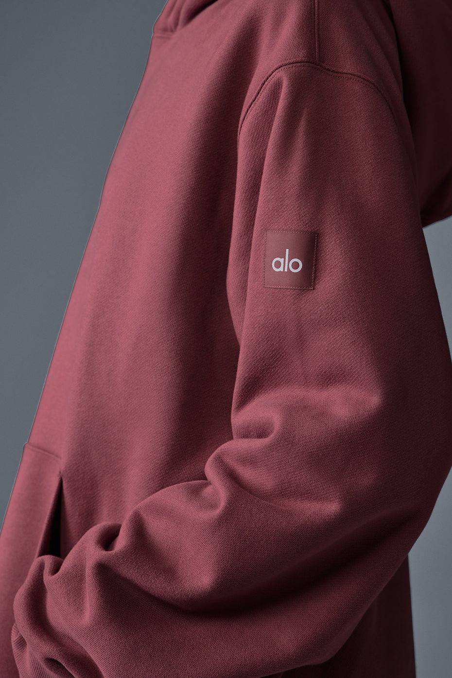 Close-up of heavyweight French terry fabric on burgundy hoodie.
