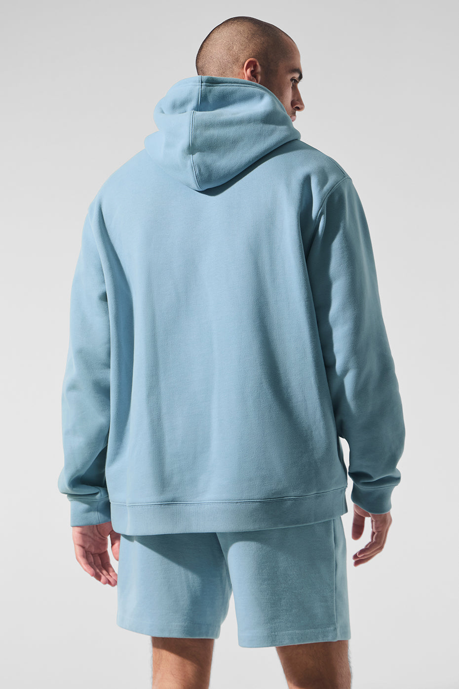 Model wearing oversized zip-up hoodie in celestial blue