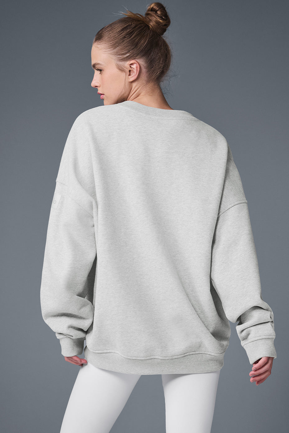 Back shot of unisex pullover highlighting the oversized dropped shoulder design