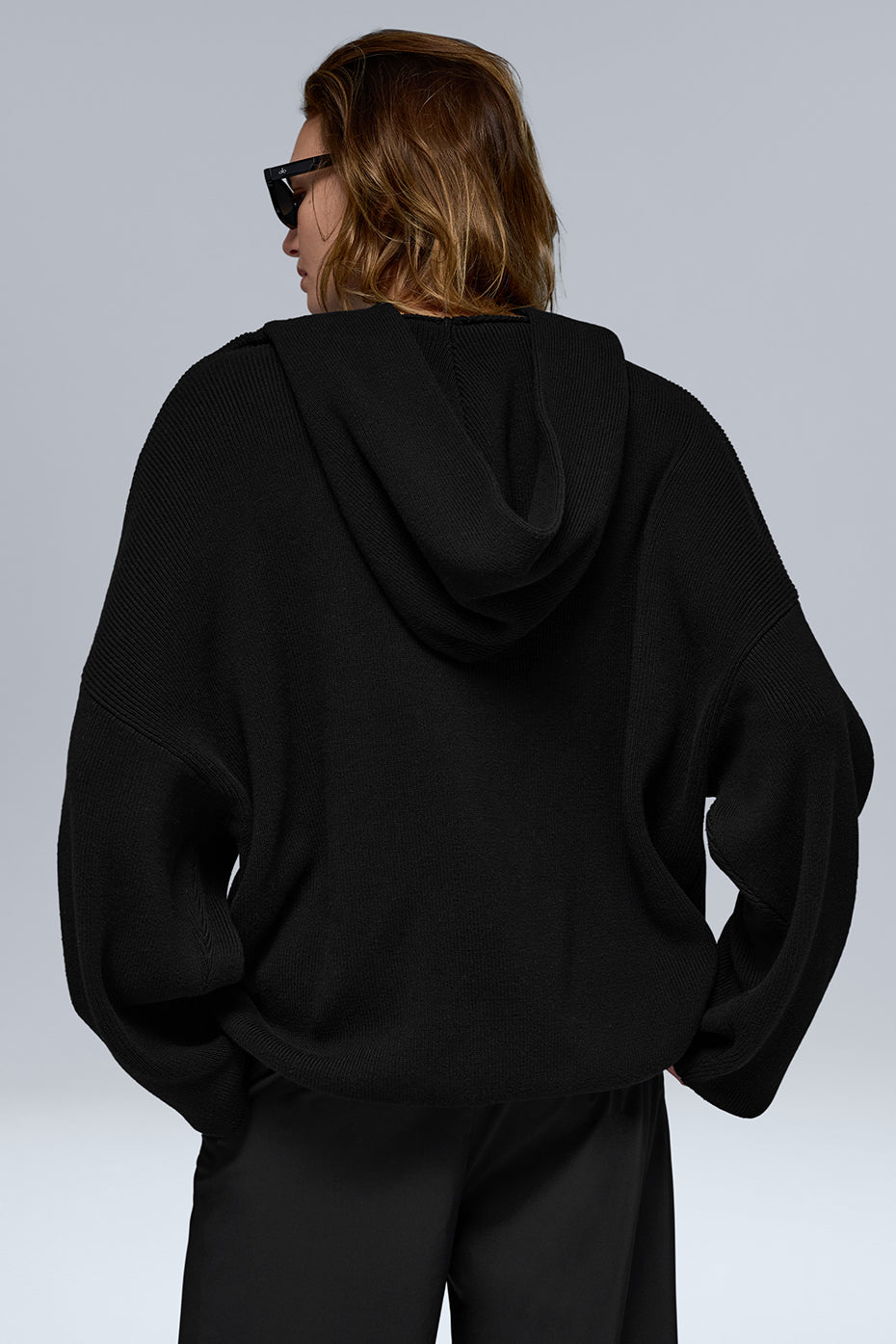 Model wearing the Scholar Comfort Hoodie in black, styled with casual sweats.